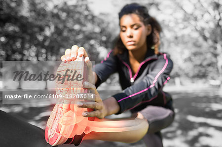 Highlighted ankle of stretching woman