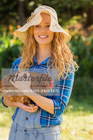 Happy blonde holding chicken