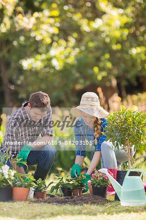 Happy young couple gardening together