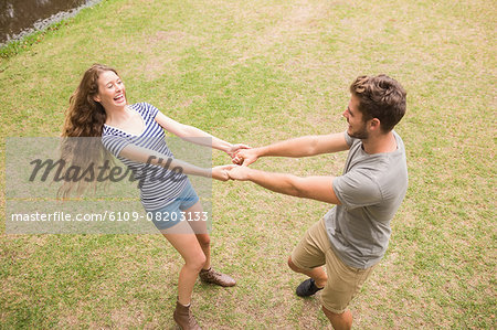 Cute couple dancing in the park