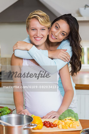 Pregnant lesbian couple hugging each other