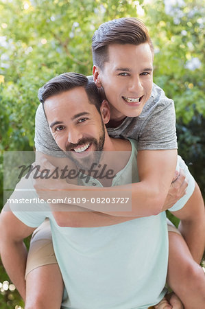 Man giving piggy back to his boyfriend