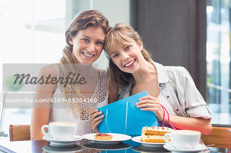 Beautiful women holding shopping bag and smiling at camera
