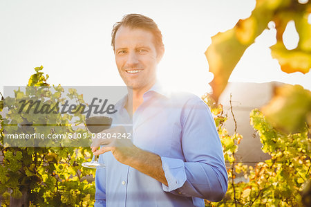 Smiling man with red wine glass