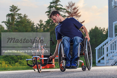 Man with spinal cord injury in his wheelchair with his custom adaptive hand cycle