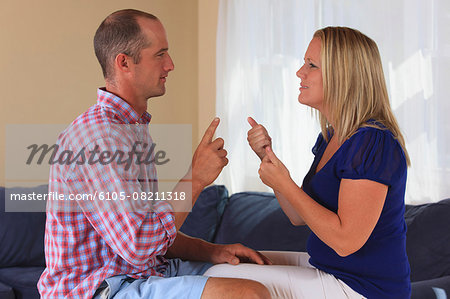 Husband and wife with hearing impairments signing 'which one' in American sign language