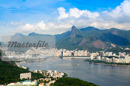 Aerial view of the city and Serra da Carioca mountains with Botafogo Bay, Corcovadao and the Christ in the foreground, Rio de Janeiro, Brazil, South America