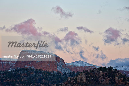 Pink clouds at dawn over sandstone formations covered with a dusting of snow, Zion National Park, Utah, United States of America, North America