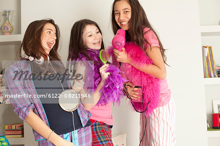 teenage girls singing , wearing pajamas