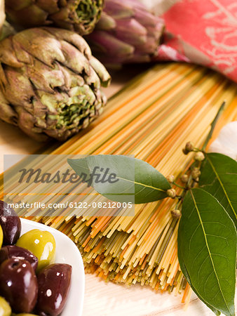 Close up of artichokes, pasta and olives