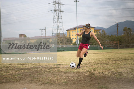 Soccer player practising in field