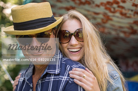 Portrait of mature man and girlfriend wearing sunglasses
