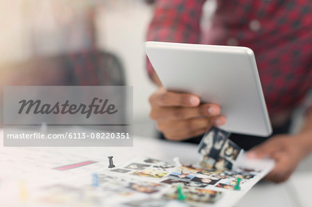 Close up fashion designer with digital tablet and photograph proofs