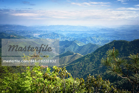 Misty mountain chains and valley with village as seen from Tian Mu Shan peak, Zhejiang, China, Asia