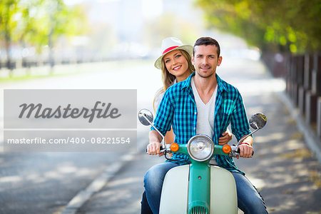 Young couple on a scooter outdoors