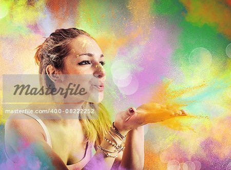 Girl blowing dust colored like a rainbow