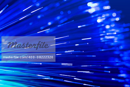 bunch of optical fibres flying from deep as blurred abstract technology background