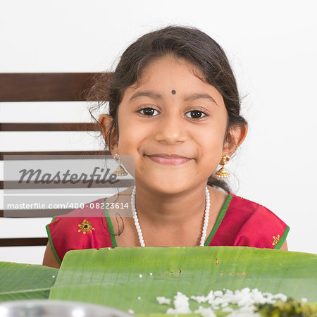 Indian family dining at home. Photo of Asian child eating rice. India culture.