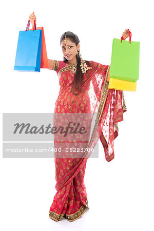 Indian woman in traditional sari shopping for diwali festival, full length standing isolated on white background.