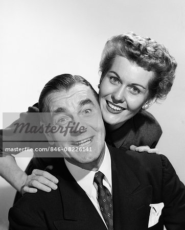 1950s PORTRAIT SMILING MAN AND WOMAN HEADS TOUCHING EAGER FACIAL EXPRESSION LOOKING AT CAMERA