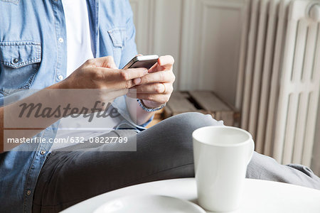 Man catching up with emails while having morning coffee