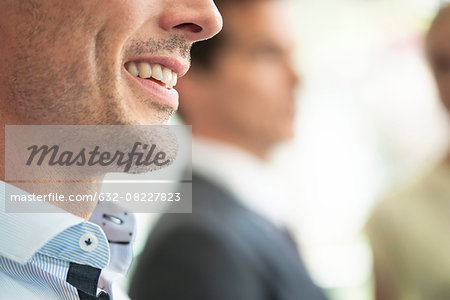 Businessman smiling, close-up