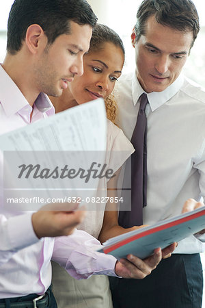 Businessman discussing documents with colleagues