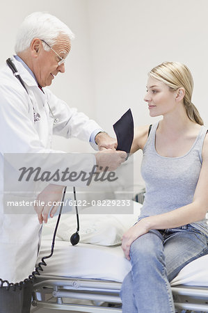 Doctor taking patient's blood pressure