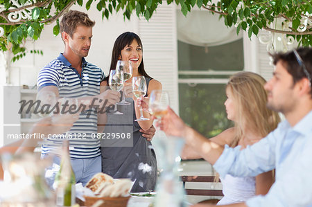 Friends toasting each other outdoors