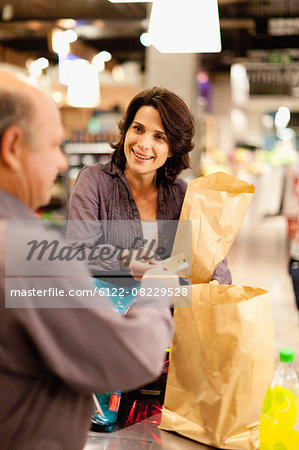 Woman buying groceries with credit card