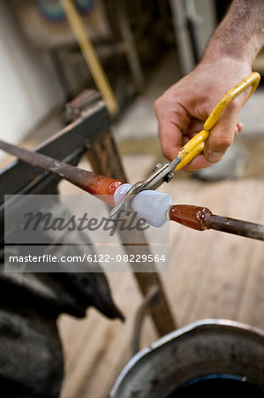 Glassblower snipping hot glass