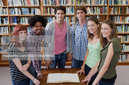 Students reading book in library