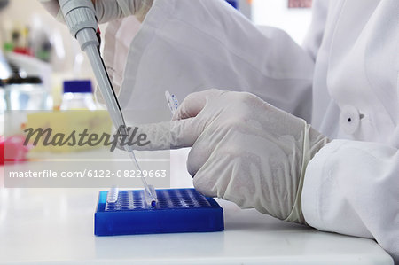 Scientist using pipette and test tube