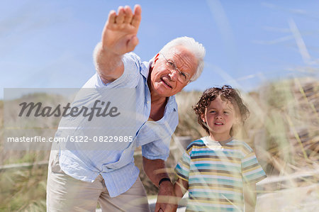 Older man and grandson standing outdoors