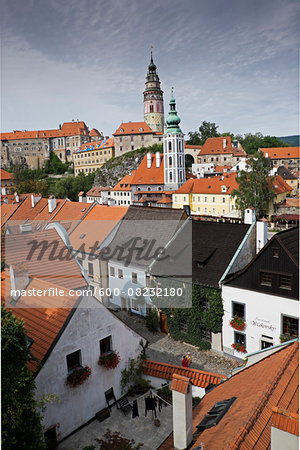 Overview of city and rooftops with the tower of St Jost Church and the tower of Cesky Krumlov Castle in the background, Cesky Krumlov, Czech Replublic.