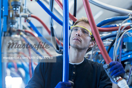 Factory technician checking network cables