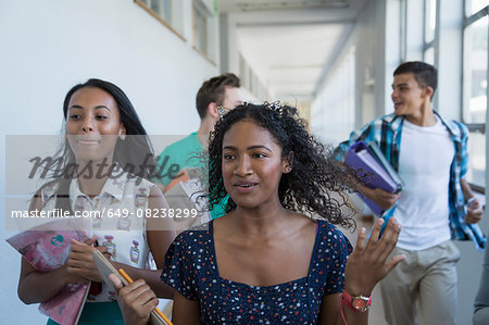 Students running down hallway, laughing