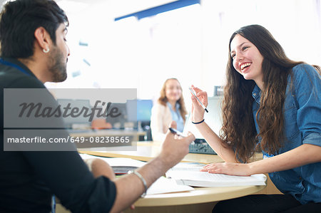 Teacher and female student having classroom tutorial