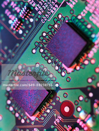 Close up detail of green and purple computer circuit board