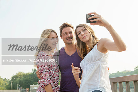 Group of friends taking self portrait outdoors