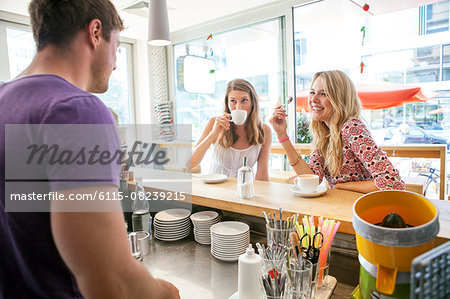 Two women have a cup of coffee in restaurant