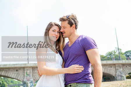 Happy young couple embracing outdoors