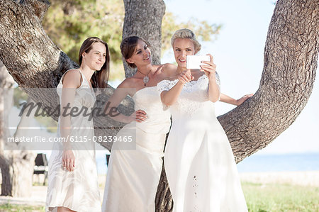 Bride and bridesmaids taking photo of themselves