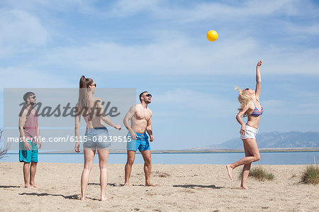 Group of friends playing beach volleyball