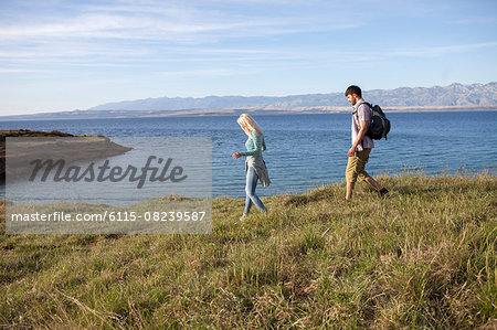 Young couple hiking along coastal path