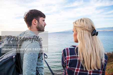 Young couple standing on water's edge