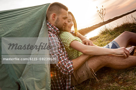 Happy couple embracing at campsite