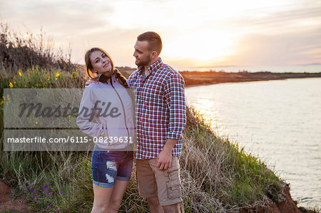 Portrait of happy couple on water's edge