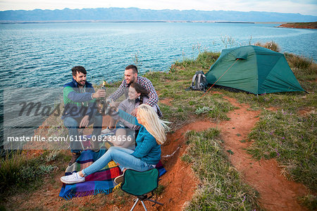 Group of friends at campsite celebrating