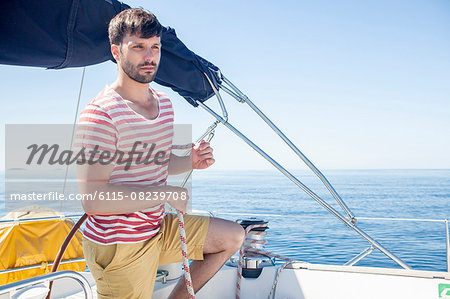 Young man overlooking sea on sailboat, Adriatic Sea